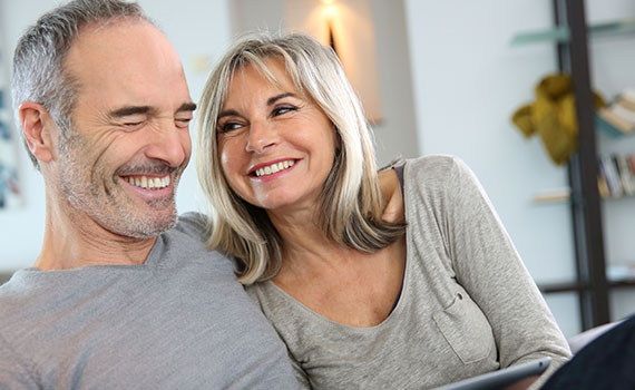 Mature couple smiling at home